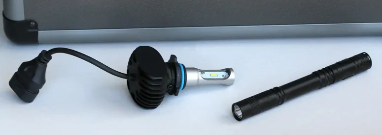 A flashlight and lightbulb on a table