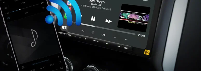 A cellphone with Bluetooth bars coming out of it going towards a car audio radio screen